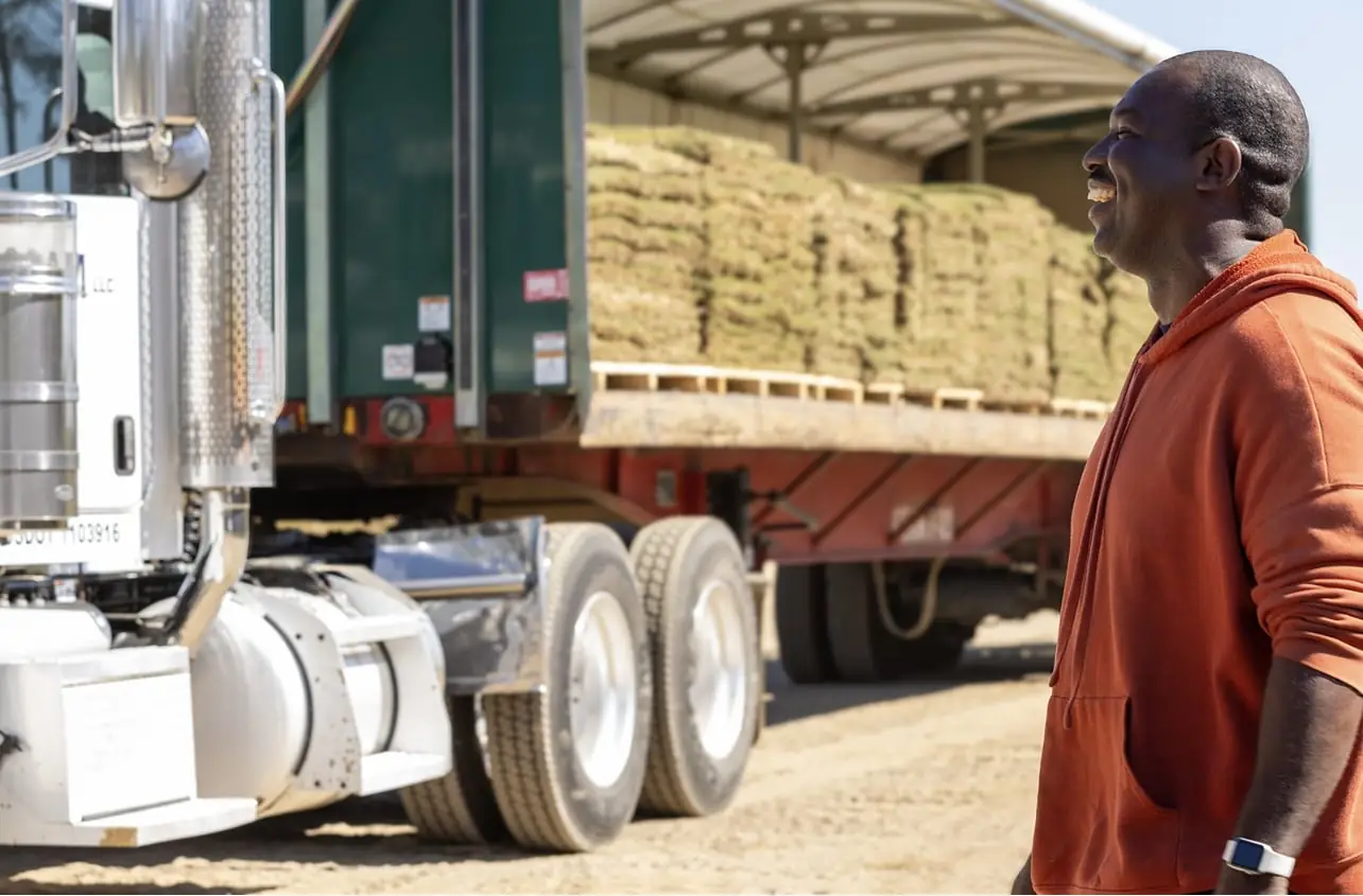 A Sodmasters driver beside a loaded truck at the Georgia farm